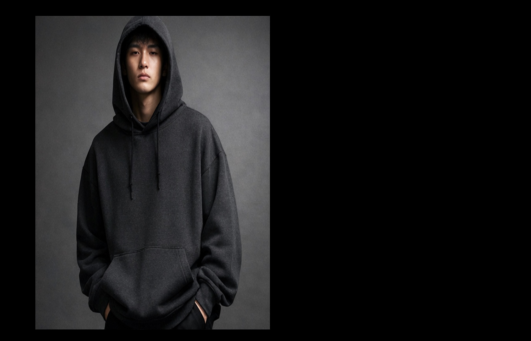 Model wearing DSTRKT heavyweight hoodie against a black field